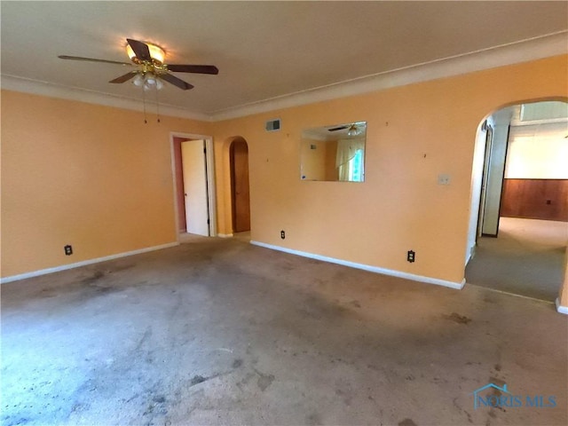 651 Park St, Napoleon, OH 43545 - carpeted empty room with arched walkways, a ceiling fan, and baseboards