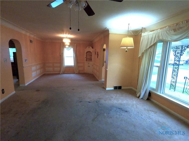 651 Park St, Napoleon, OH 43545 - carpeted empty room featuring arched walkways, a ceiling fan, and baseboards