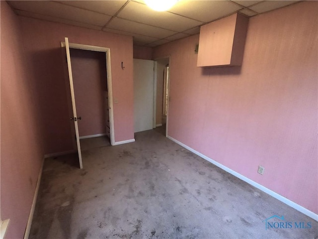 651 Park St, Napoleon, OH 43545 - unfurnished bedroom with a paneled ceiling, baseboards, and carpet