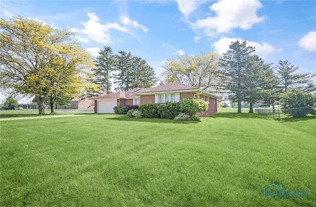 403 S N Curtice Rd, Oregon, OH 43616 - view of front facade with an attached garage and brick siding