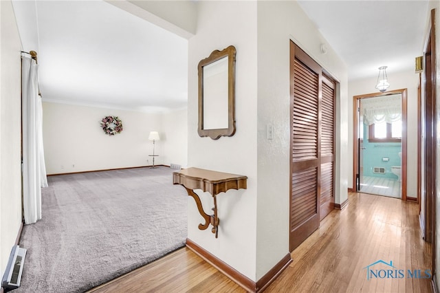 403 S N Curtice Rd, Oregon, OH 43616 - hall featuring baseboards and light wood-style flooring