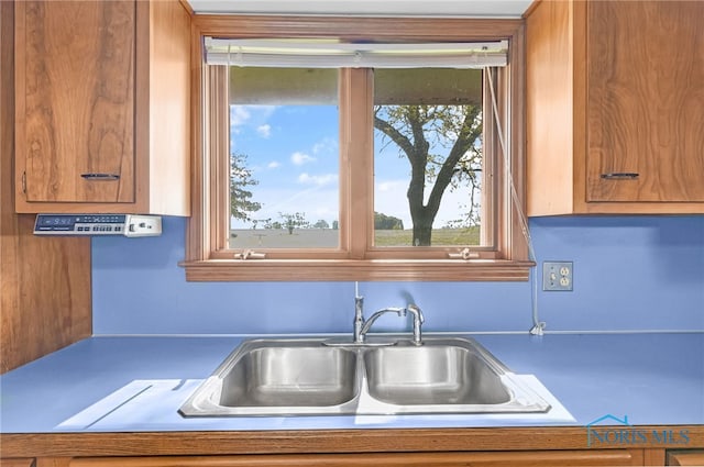 403 S N Curtice Rd, Oregon, OH 43616 - kitchen with a sink and brown cabinetry