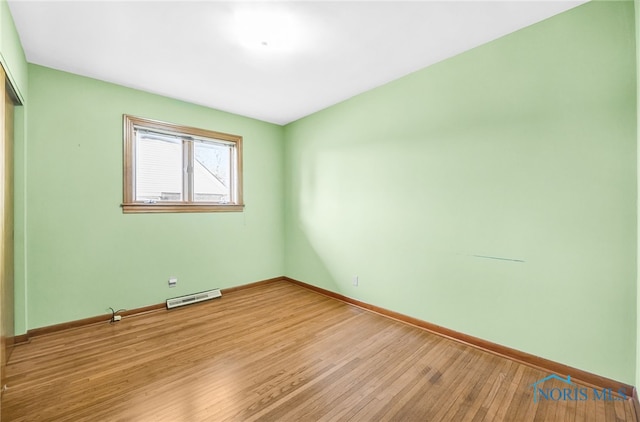 403 S N Curtice Rd, Oregon, OH 43616 - unfurnished bedroom featuring a closet, wood finished floors, and baseboards
