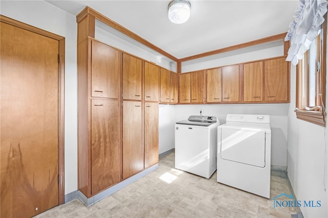 403 S N Curtice Rd, Oregon, OH 43616 - washroom featuring cabinet space, independent washer and dryer, and light floors