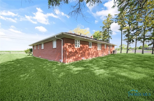403 S N Curtice Rd, Oregon, OH 43616 - view of home's exterior with a lawn and brick siding