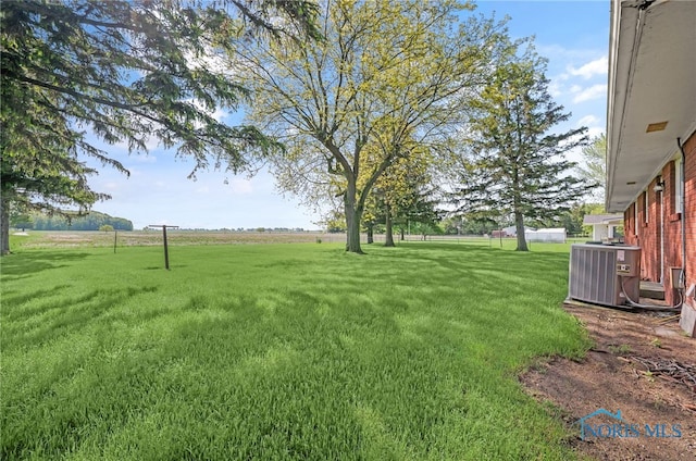 403 S N Curtice Rd, Oregon, OH 43616 - view of grassy yard featuring central air condition unit