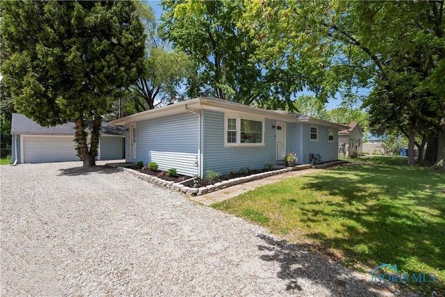 ranch-style home with a front lawn, a garage, and gravel driveway