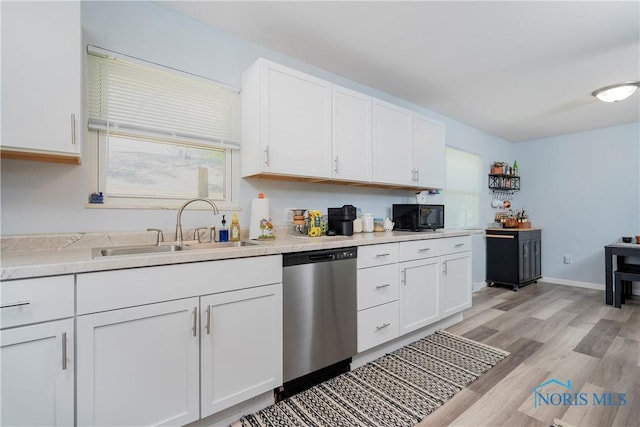 kitchen with dishwasher, a sink, black microwave, and white cabinets