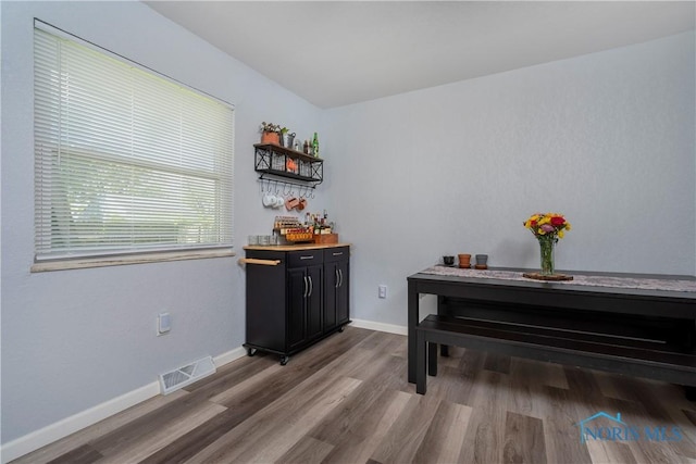 dining area featuring wood finished floors and baseboards