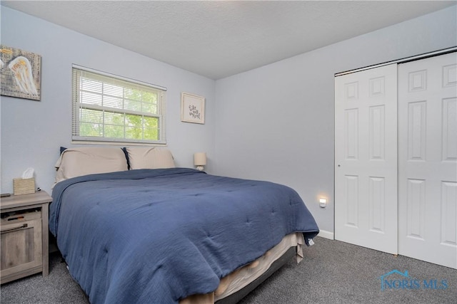 bedroom featuring carpet flooring, a closet, and baseboards