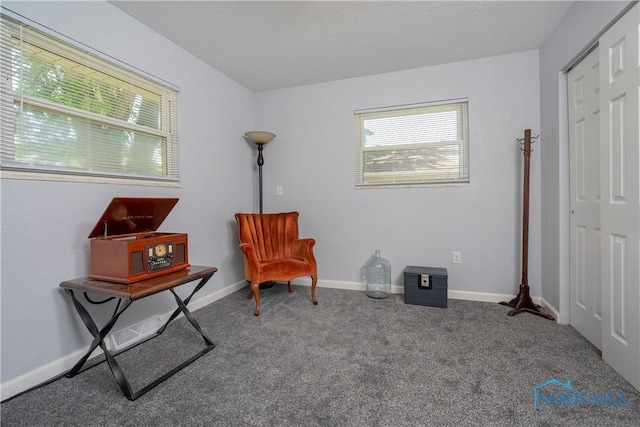 sitting room featuring carpet and baseboards