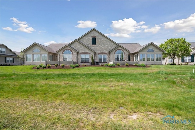 2730 Canterbury Cir Unit 23B, Port Clinton, OH 43452 - french provincial home featuring a front lawn, a sunroom, and stone siding