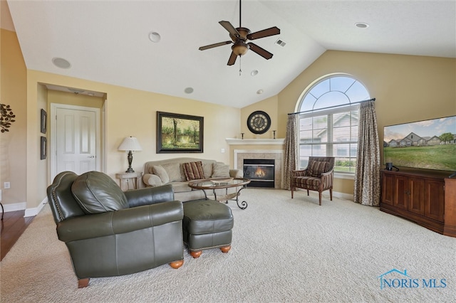 2730 Canterbury Cir Unit 23B, Port Clinton, OH 43452 - carpeted living area with ceiling fan, baseboards, a tiled fireplace, and high vaulted ceiling