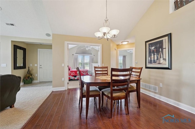 2730 Canterbury Cir Unit 23B, Port Clinton, OH 43452 - dining room with a chandelier, dark wood finished floors, baseboards, and vaulted ceiling