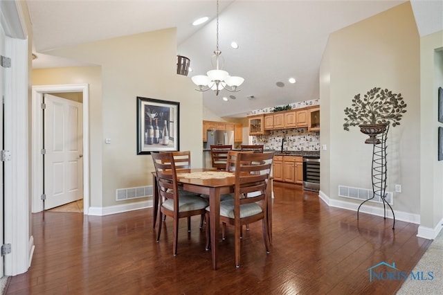 2730 Canterbury Cir Unit 23B, Port Clinton, OH 43452 - dining space featuring vaulted ceiling, a chandelier, dark wood-style flooring, and baseboards