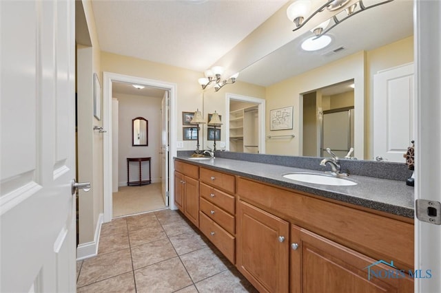 2730 Canterbury Cir Unit 23B, Port Clinton, OH 43452 - full bath with double vanity, a stall shower, tile patterned flooring, and baseboards