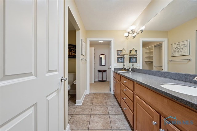 2730 Canterbury Cir Unit 23B, Port Clinton, OH 43452 - full bath with toilet, double vanity, a chandelier, tile patterned floors, and baseboards