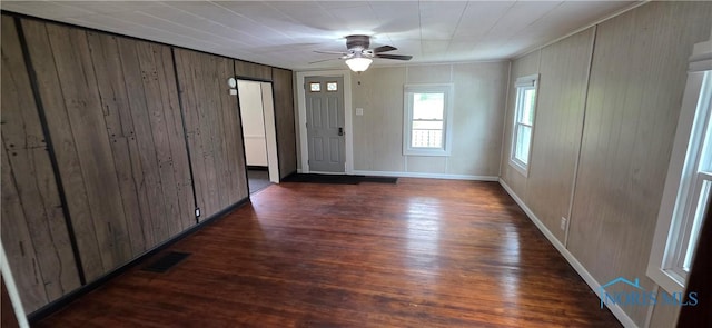 1037 Fishlock Ave, Findlay, OH 45840 - unfurnished room with dark wood-type flooring, ceiling fan, wooden walls, baseboards, and ornamental molding