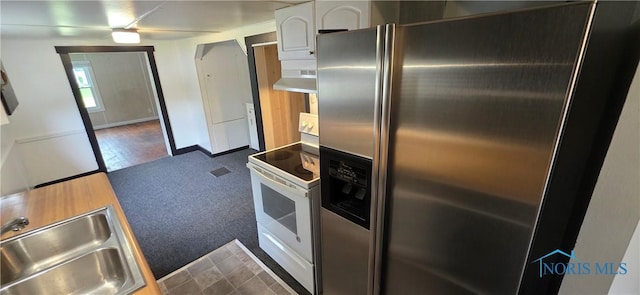 1037 Fishlock Ave, Findlay, OH 45840 - kitchen with stainless steel fridge, electric stove, a sink, under cabinet range hood, and dark colored carpet