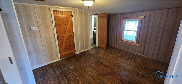 1037 Fishlock Ave, Findlay, OH 45840 - spare room with hardwood / wood-style floors, wooden walls, and a textured ceiling