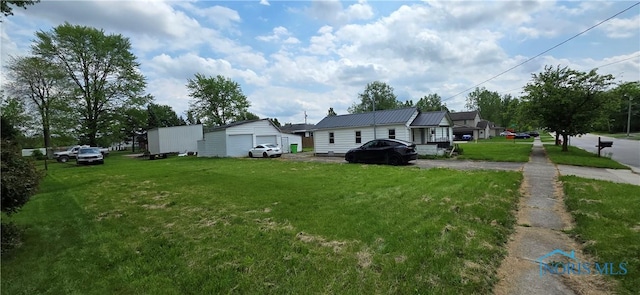 1037 Fishlock Ave, Findlay, OH 45840 - view of green lawn featuring a detached garage and an outdoor structure