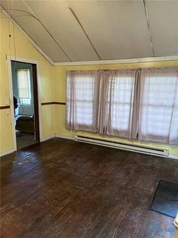 701 E Wayne St, Paulding, OH 45879 - unfurnished room with lofted ceiling, hardwood / wood-style floors, baseboard heating, and baseboards
