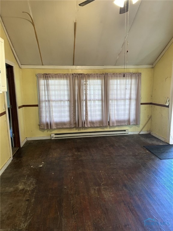 701 E Wayne St, Paulding, OH 45879 - empty room with lofted ceiling, wood-type flooring, a ceiling fan, and baseboards
