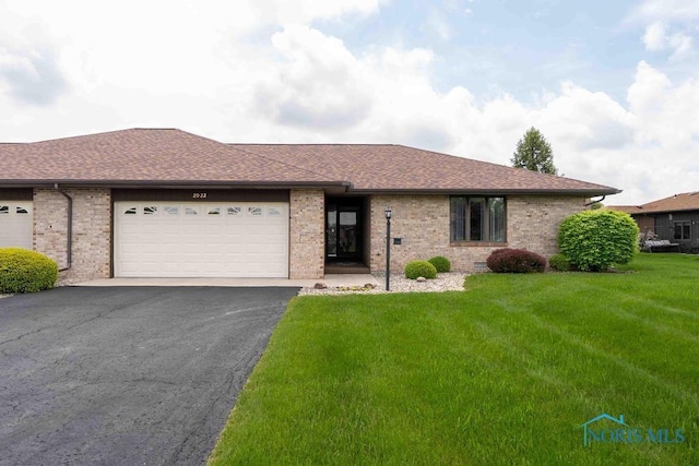 2023 Bluestone Dr, Findlay, OH 45840 - ranch-style home with driveway, a front lawn, an attached garage, roof with shingles, and brick siding