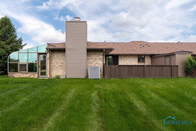 2023 Bluestone Dr, Findlay, OH 45840 - rear view of house featuring a chimney, brick siding, and central air condition unit