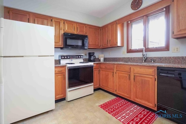 2023 Bluestone Dr, Findlay, OH 45840 - kitchen with black appliances, a sink, brown cabinetry, and light floors