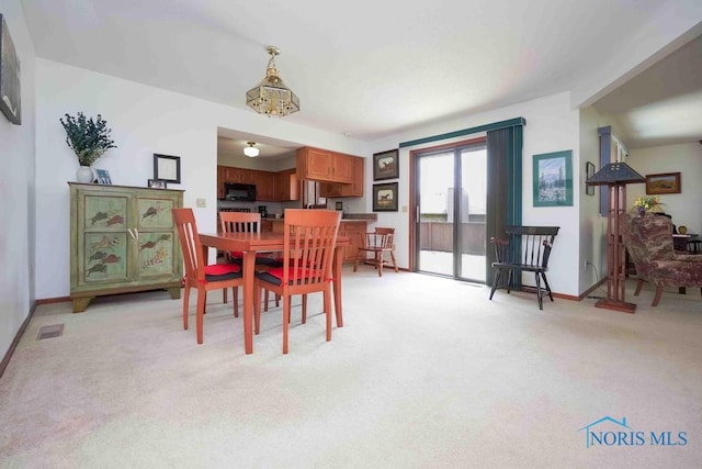 2023 Bluestone Dr, Findlay, OH 45840 - dining space featuring light colored carpet and baseboards