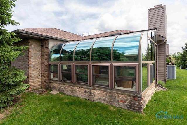 2023 Bluestone Dr, Findlay, OH 45840 - view of home's exterior with a chimney, a lawn, cooling unit, and roof with shingles