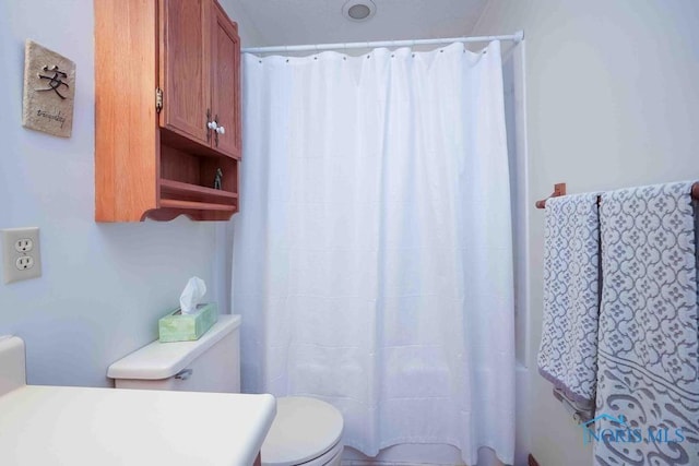 2023 Bluestone Dr, Findlay, OH 45840 - bathroom with toilet and a shower with shower curtain