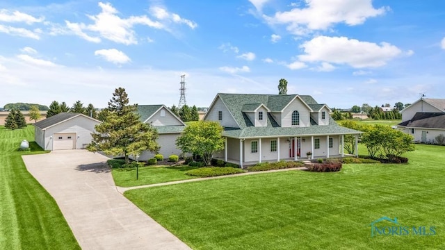 14360 County Road 2, Swanton, OH 43558 - view of front of house with covered porch, concrete driveway, an outbuilding, and a front yard