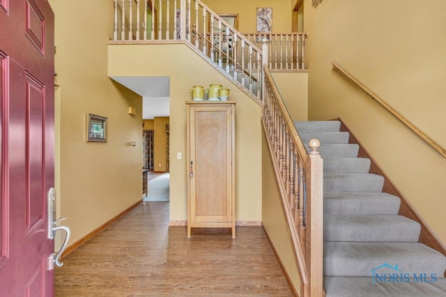 14360 County Road 2, Swanton, OH 43558 - foyer featuring a towering ceiling, wood finished floors, stairway, and baseboards