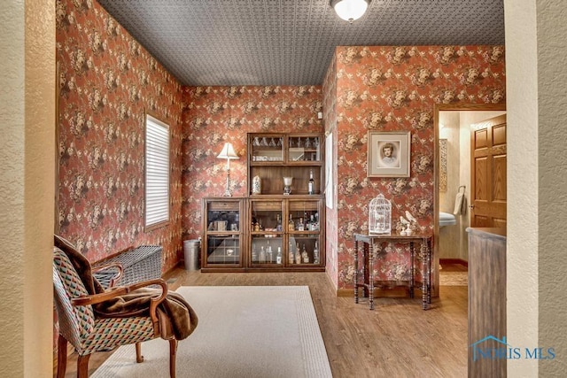14360 County Road 2, Swanton, OH 43558 - sitting room with wallpapered walls, wood finished floors, and baseboards