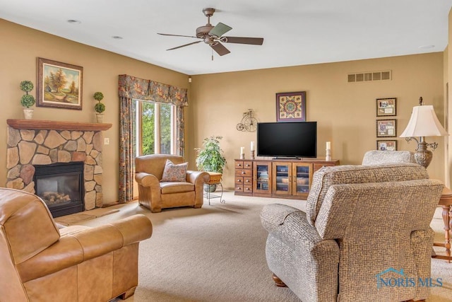 14360 County Road 2, Swanton, OH 43558 - living area with carpet, a ceiling fan, and a stone fireplace
