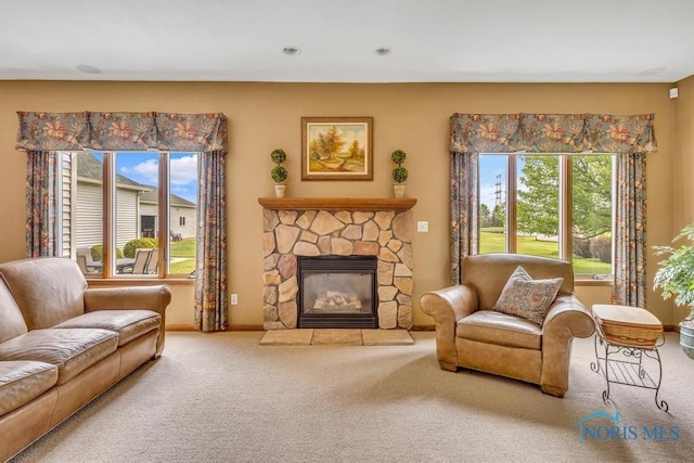 14360 County Road 2, Swanton, OH 43558 - carpeted living area featuring a stone fireplace and baseboards