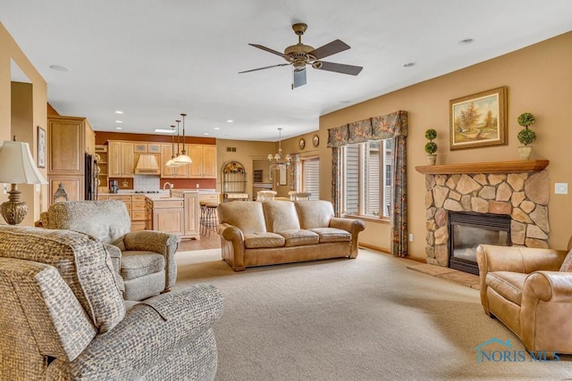14360 County Road 2, Swanton, OH 43558 - living area featuring a ceiling fan, light colored carpet, recessed lighting, a chandelier, and a fireplace