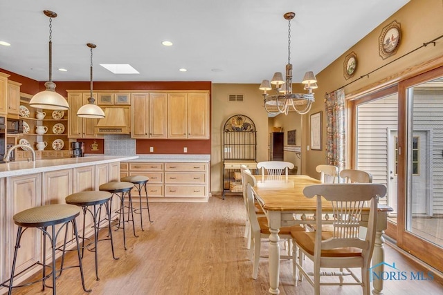 14360 County Road 2, Swanton, OH 43558 - dining room featuring a skylight, light wood-style flooring, recessed lighting, and a chandelier