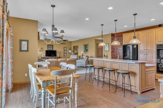 14360 County Road 2, Swanton, OH 43558 - dining space with a chandelier, light wood-type flooring, recessed lighting, and baseboards