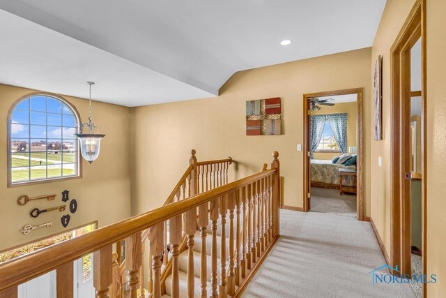 14360 County Road 2, Swanton, OH 43558 - hall featuring an upstairs landing, carpet flooring, baseboards, and vaulted ceiling
