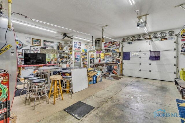 14360 County Road 2, Swanton, OH 43558 - garage with a workshop area, a garage door opener, and a ceiling fan