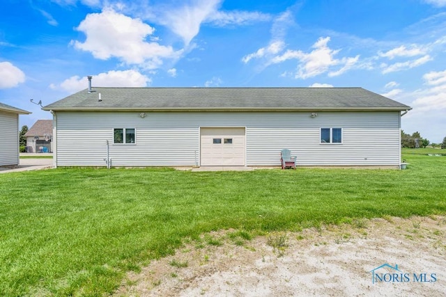 14360 County Road 2, Swanton, OH 43558 - rear view of house featuring a lawn and a detached garage