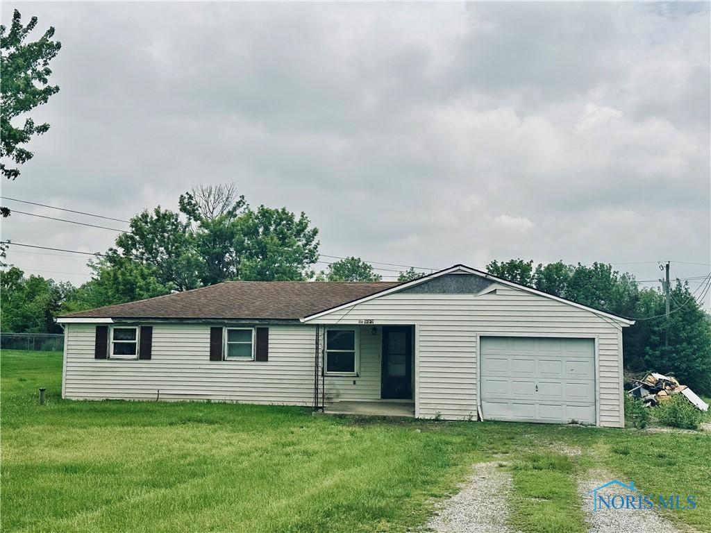 3227 Kaiser Rd, Fort Loramie, OH 45844 - ranch-style house with driveway, a front yard, and an attached garage