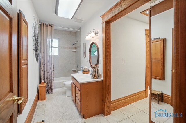1482 Township Road 55, Ada, OH 45810 - bathroom with tile patterned floors, vanity, shower / tub combo with curtain, toilet, and baseboards