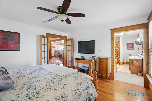 1482 Township Road 55, Ada, OH 45810 - bedroom with french doors, light wood-style floors, ceiling fan, and connected bathroom