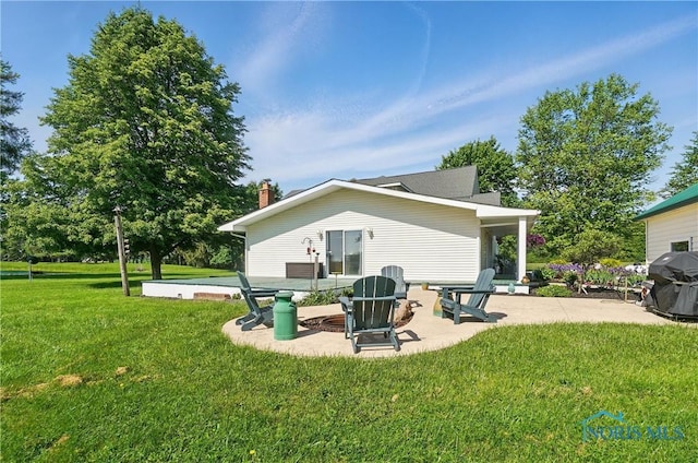 1482 Township Road 55, Ada, OH 45810 - back of property with a patio area, a lawn, and a chimney