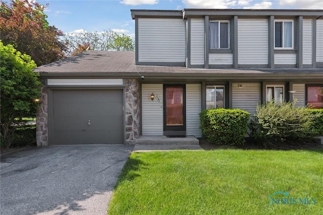 2540 Plum Leaf Ln, Toledo, OH 43614 - view of front of home featuring a garage, driveway, and a front lawn