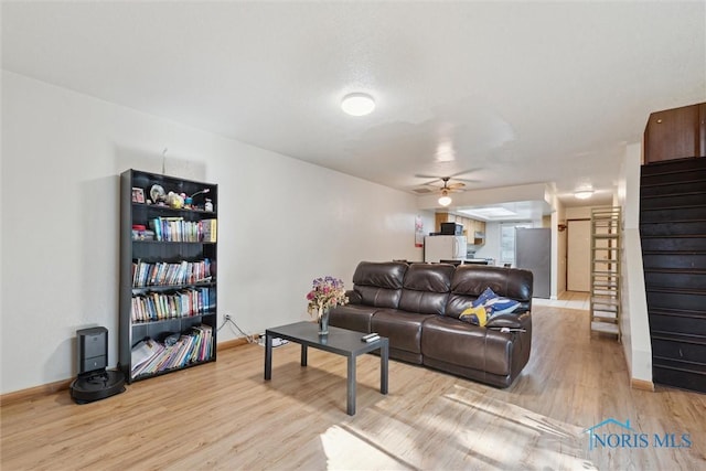2540 Plum Leaf Ln, Toledo, OH 43614 - living area with a ceiling fan, stairs, light wood-style floors, and baseboards